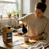Woman pours coffee in casual home kitchen