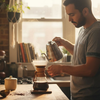 Man making specialty coffee in sunlit kitchen
