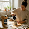Woman pours coffee in casual home kitchen