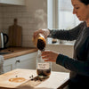 Home barista pouring roasted coffee beans