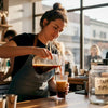Barista pouring cold brew at coffee shop