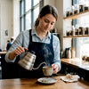 Barista pouring coffee in upscale city café