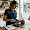Barista weighing beans at café counter